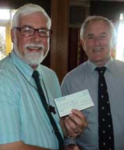 Image of our chair receiving a cheque from a funder